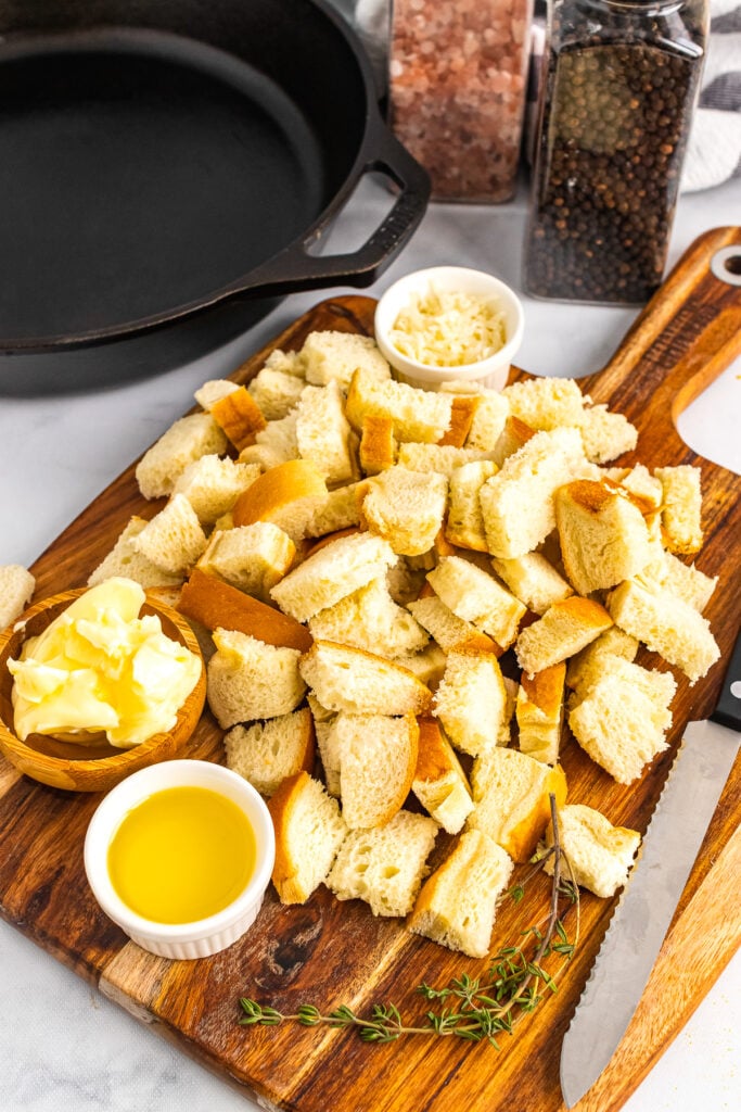 Torn bread for seasoned croutons cooked in cast iron.