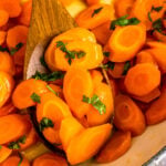 Easy to make glazed carrots served on a wooden spoon.