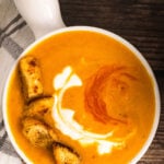 Roasted Sweet Potato Soup in a white bowl with a handle.