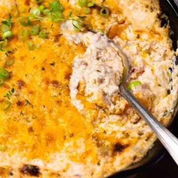 Baked ground beef casserole with melted cheddar cheese and green onions in black skillet, IMG 0638