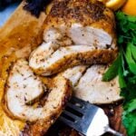 Air Fryer Turkey Breasts on a cutting board with a silver fork