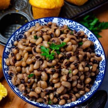 Bowl of Black Eyed Peas served with corn bread muffins.