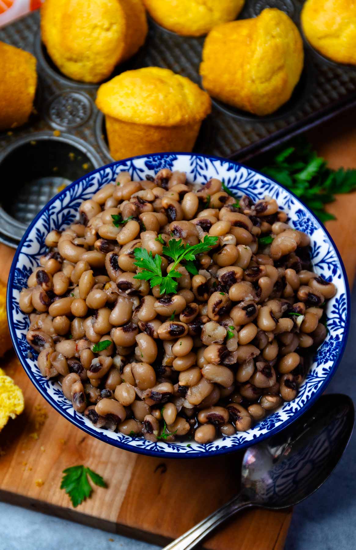 Bowl of Black Eyed Peas served with corn bread muffins.