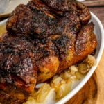 Balsamic Glazed Pork Roast iwith onion on a white serving platter.