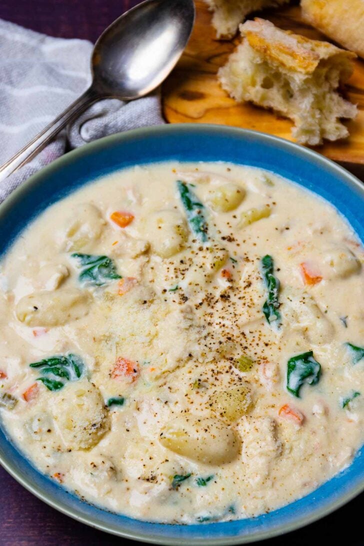 Creamy Gnocchi Chicken Soup in a blue bowl.