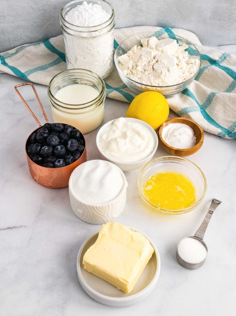 Fresh blueberries, lemon, butter, and other ingredients to make scones.