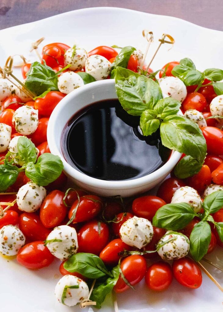 Caprese Wreath Salad served for Christmas with balsamic reduction.