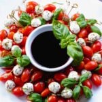 Christmas Caprese Wreath Salad with balsamic reduction served for the holidays.