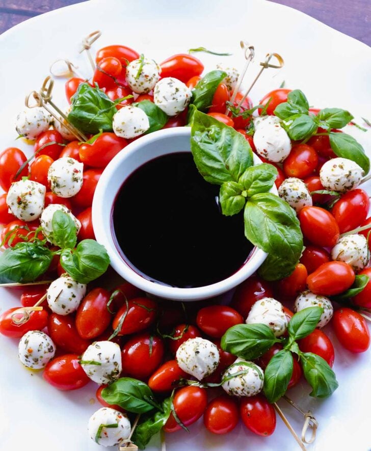 Christmas Caprese Wreath Salad with balsamic reduction served for the holidays.