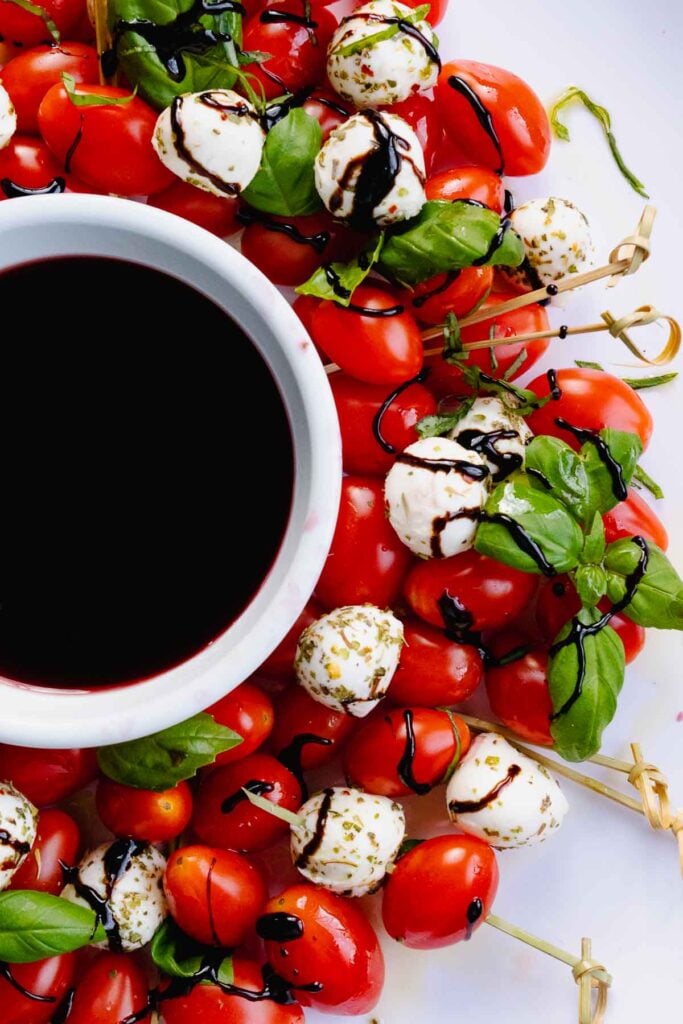 Caprese Wreath Salad served with balsamic reduction is the perfect party appetizer.