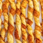Puffed Pastry Cheese Straws baked to perfection on a serving tray.
