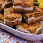 Snickerdoodle Cheesecake Bars served on a white platter for dessert.