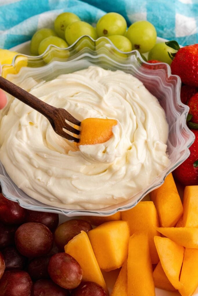 Fork with cantelope dipped in 3-ingredient fruit dip.