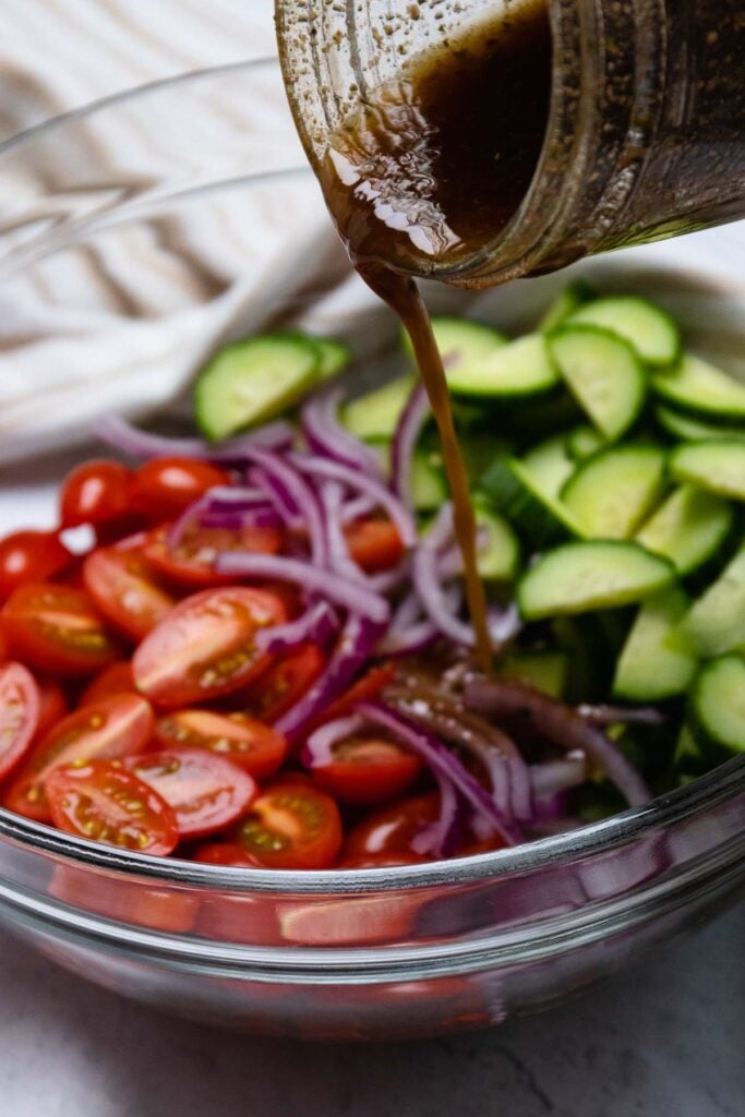 Homemade dressing made with Dan-O's Spicy Seasoning poured over tomatoes and cucumbers.