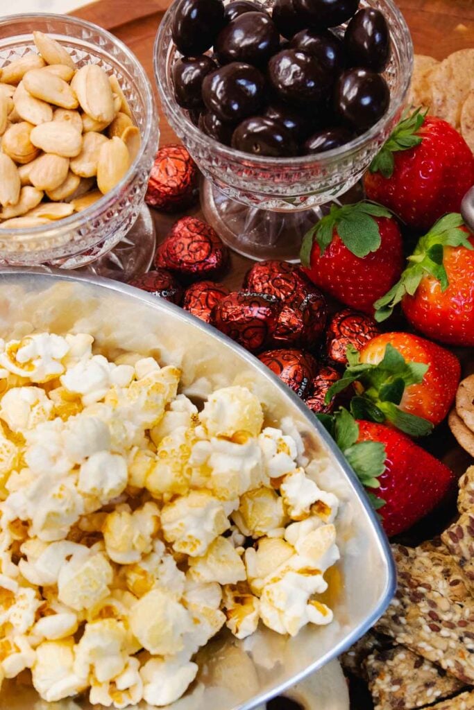 Popcorn, strawberries, chocolate and nuts for Valentines Day Board For Two