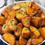 Bowl of air fryer cajun potatoes served as a side dish.
