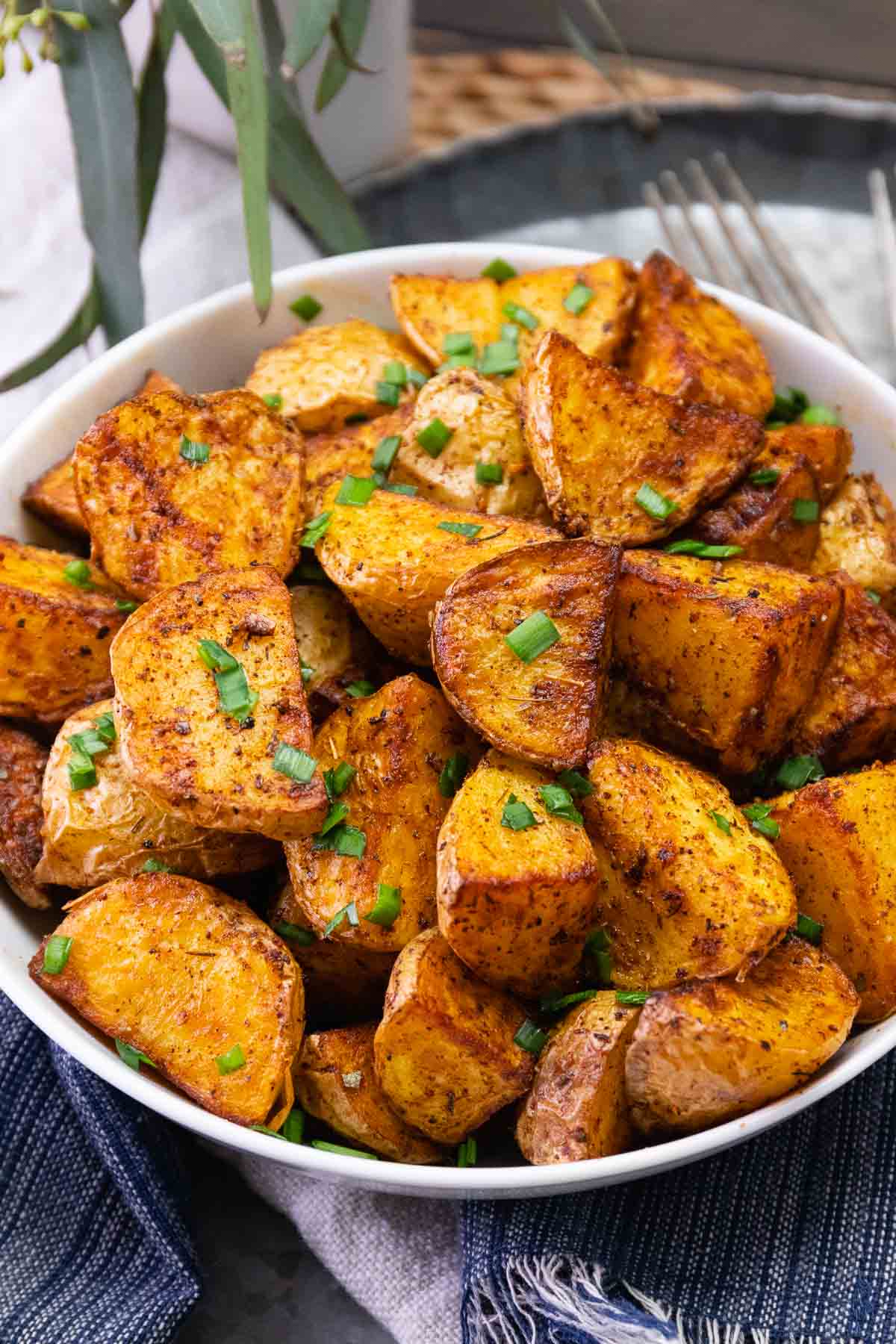 Bowl of air fryer cajun potatoes served as a side dish.
