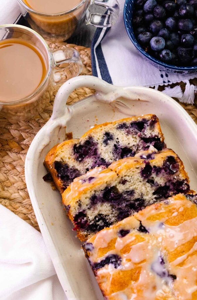 Slices of blueberry bread served with coffee.