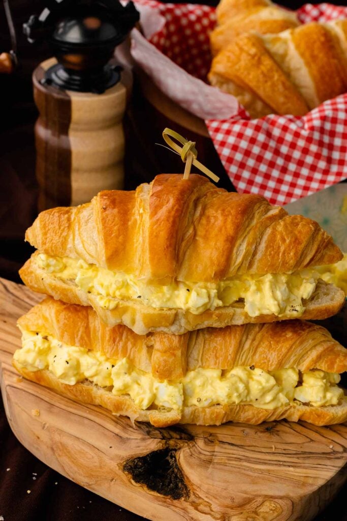 Stacked egg salad sandwiches served for lunch.