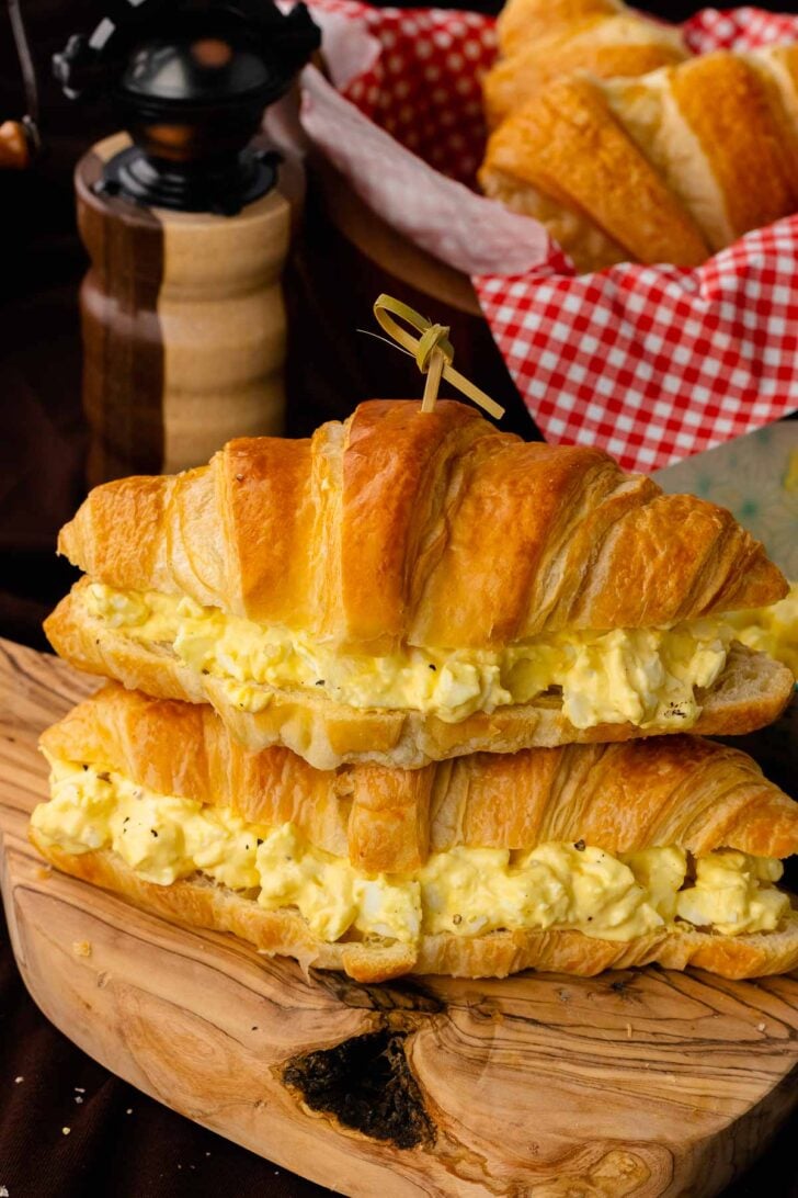 Stacked egg salad sandwiches served for lunch.