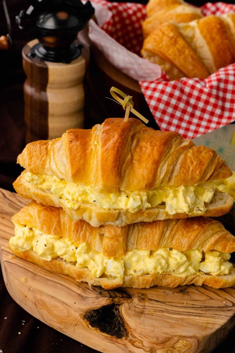 Stacked egg salad sandwiches served for lunch.