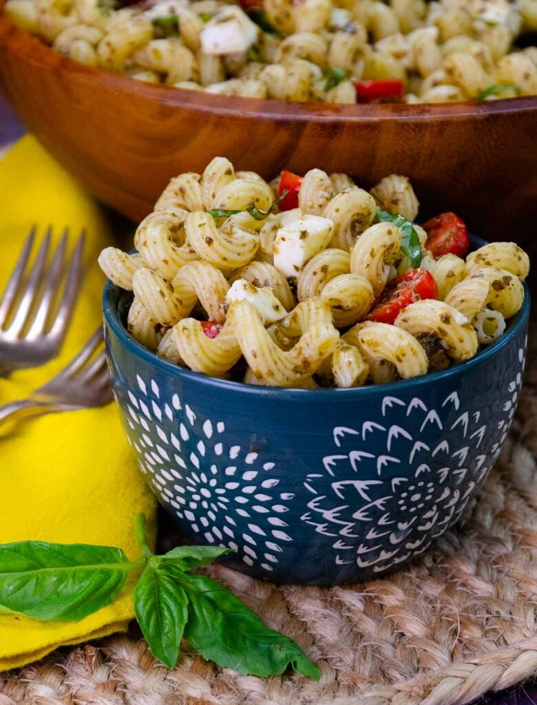 Pesto pasta salad in a small blue bowl.
