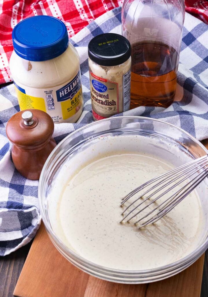 Mayonnaise, horseradish, apple cider vinegar, pepper and other ingredients whisked together for Alabama White BBQ Sauce.