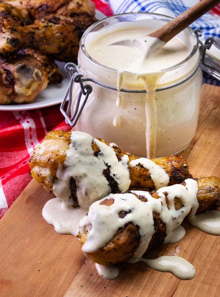 2 grilled chicken legs drizzled with Alabama White BBQ sauce for a picnic, lunch or a cookout.