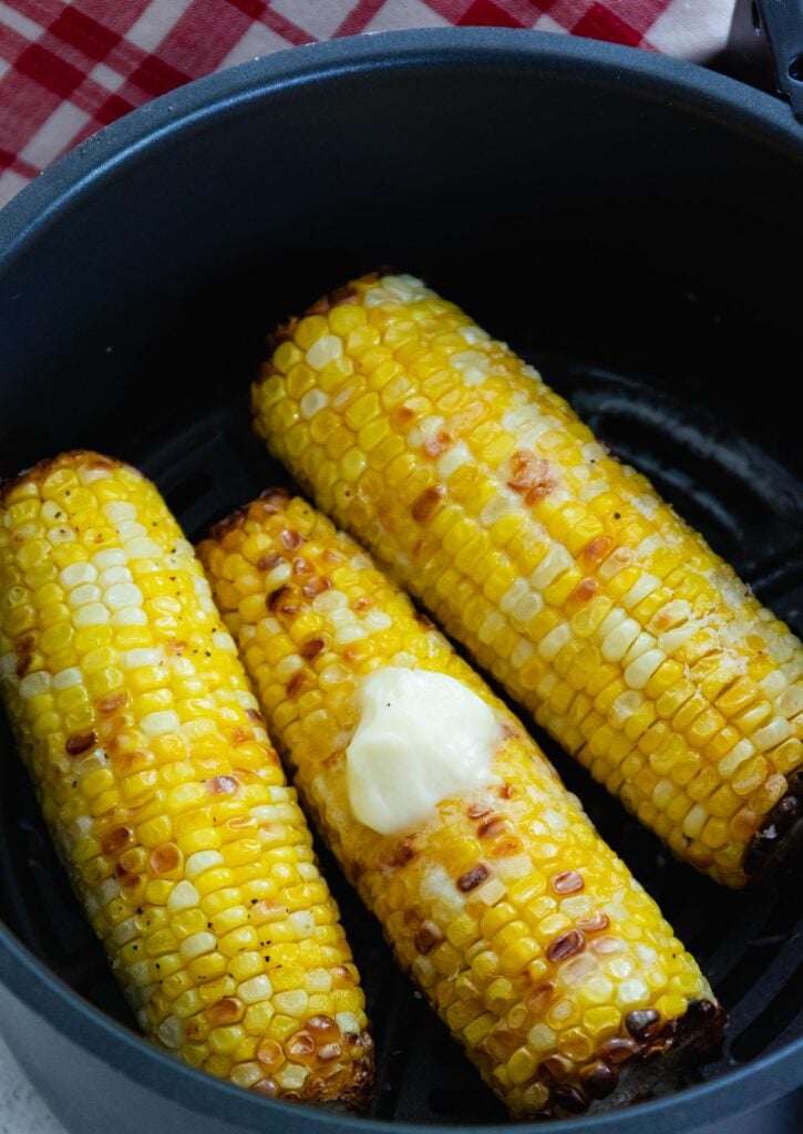 Air Fryer Corn On The Cob served with butter salt and pepper as a summer side dish.