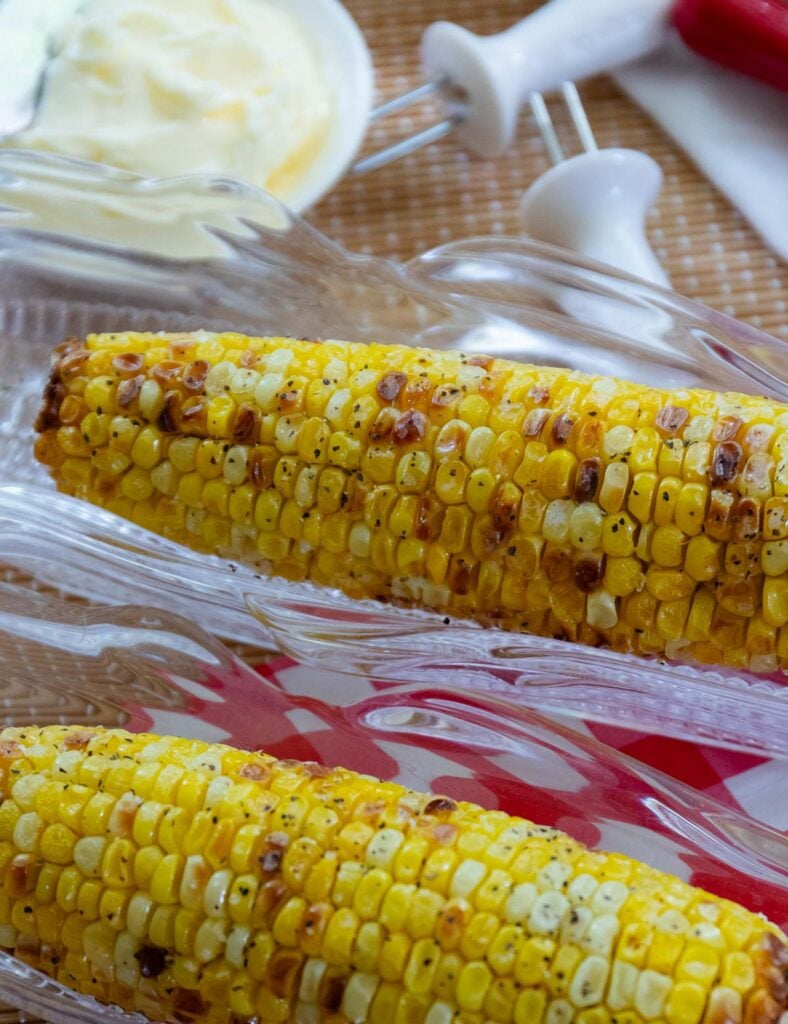 Air Fryer Corn On The Cob served with butter salt and pepper as a summer side dish.