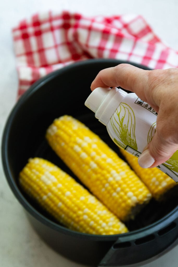 Avcado spray and corn on the cob to cook in the air fryer.
