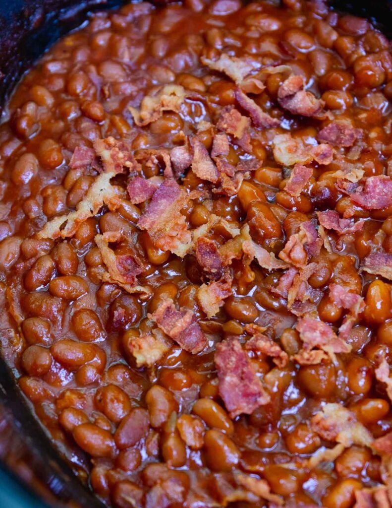 Crock Pot Baked Beans made with bacon and brown suger is the perfect summer side dish for cookouts, parties and potlucks.
