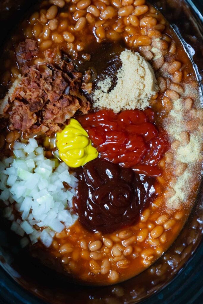 Beans, bacon, onion, brown sugar, ketchup, mustard, and garlic powder for Crock Pot Baked Beans