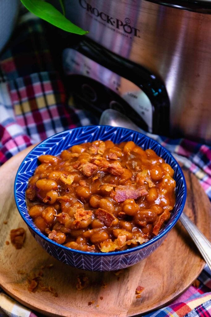 Crock Pot Baked Beans made with bacon and brown suger is the perfect summer side dish for cookouts, parties and potlucks.