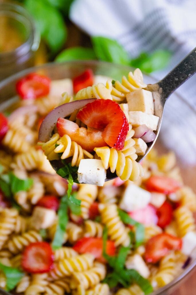 Spoonful of Strawberry Caprese Pasta Salad served for a cookout, pot luck or as a side dish.