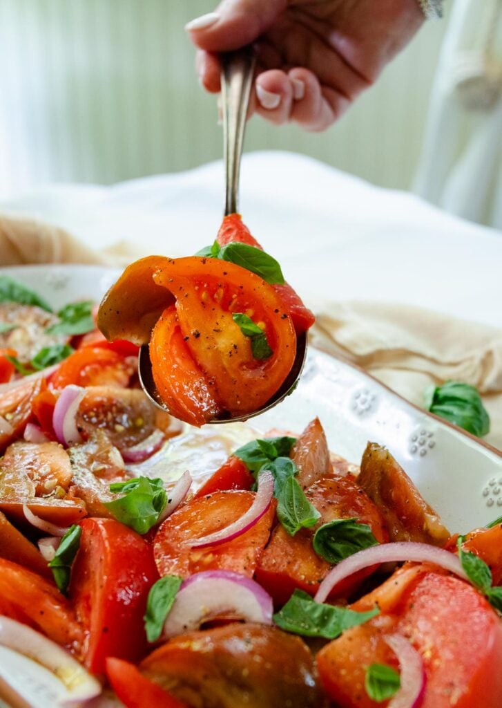 Fresh tomato Salad with basil and red onion is one of summers best side dished served with anything off the grill or just on it's own.