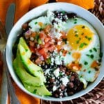 Healthy and delcious black bean breakfast burrito bowls with fried eggs, salsa and avocados.