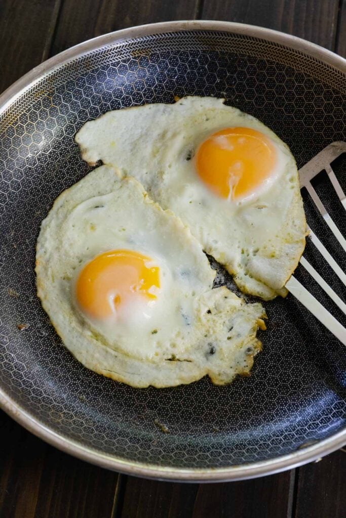 Fried eggs in a pan cooked to perfection served with breakfast burrito bowls.