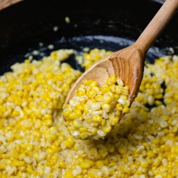 Southern Fried Corn made in a cast iron skillet with butter, a little bacon grease, salt and pepper.