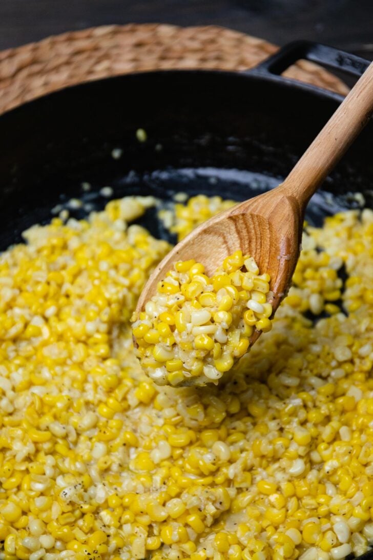 Southern Fried Corn made in a cast iron skillet with butter, a little bacon grease, salt and pepper.