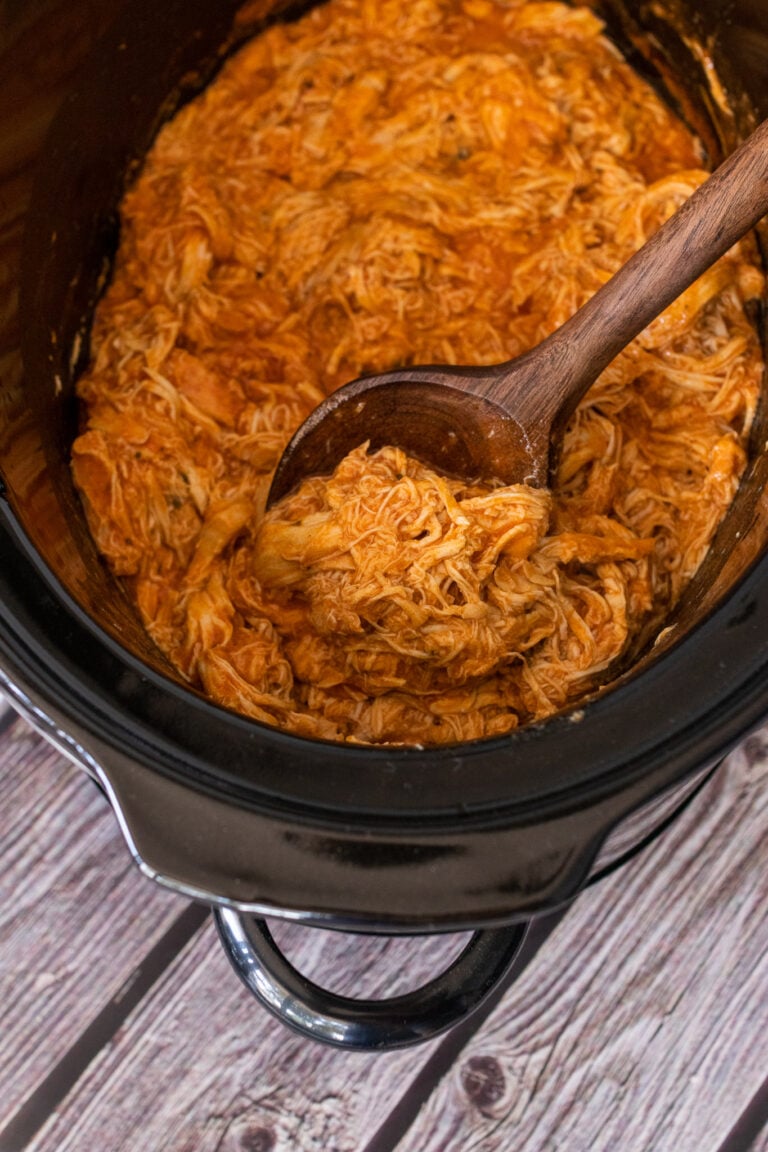 Shredded pulled chicken in slow cooker with wooden spoon for Easy Slow Cooker Dinners for Busy Weeknights (Set It and Forget It)
