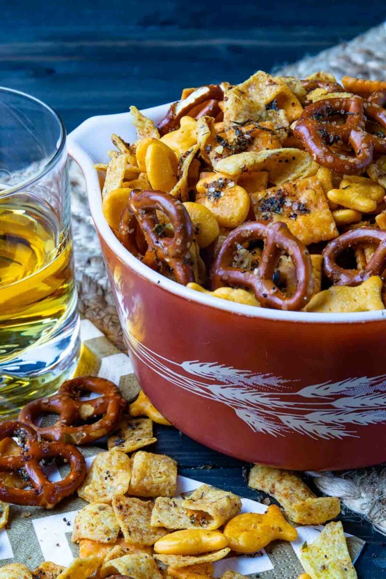 Seasoned pretzel and cheese snack mix in red bowl with beer, perfect for 35 BEST Recipes For Game Day