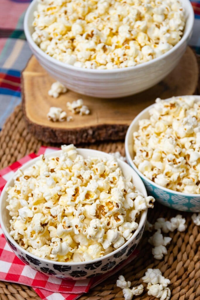 3 bowls of delicious homemade stovetop popcorn.Drizzled with melted butter and seasoned to perfection with salt.
