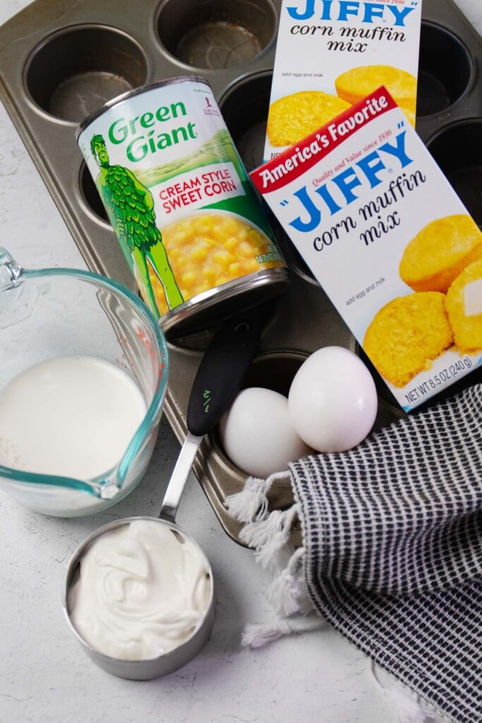 Ingredients for creamed corn cornbread muffins made with Jiffy corn mix.