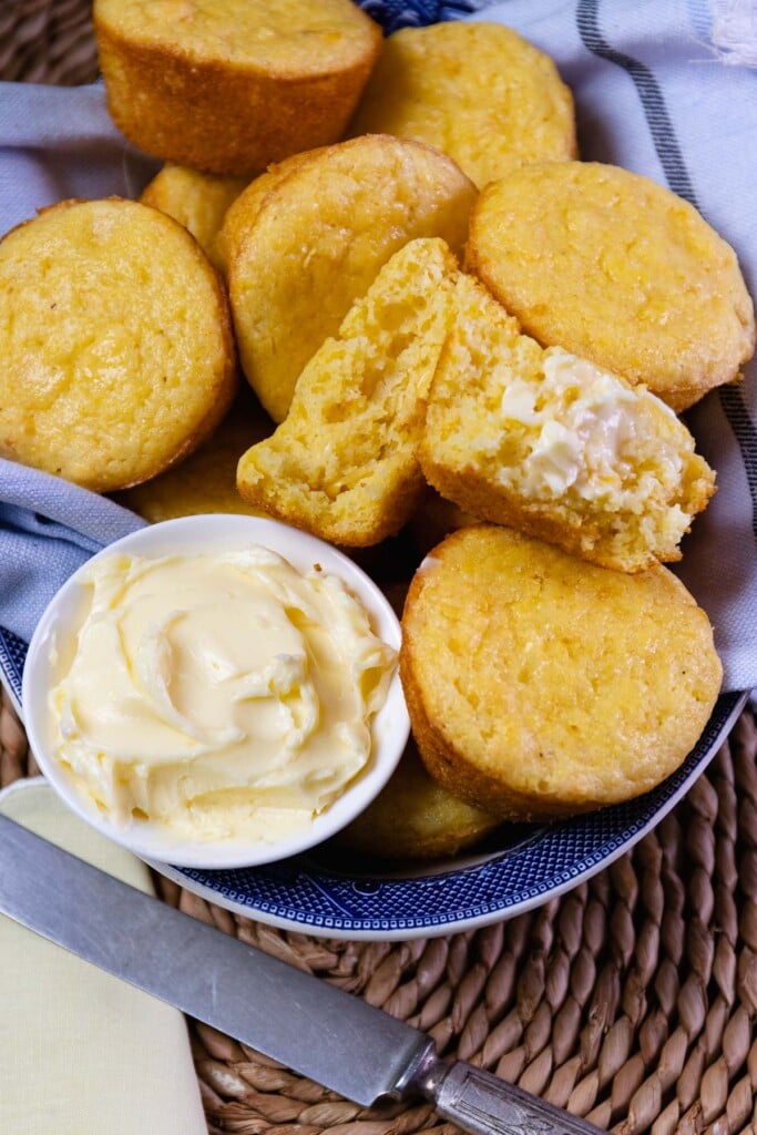Corn Muffins served with butter, warm in a blue bowl for lunch or dinner.