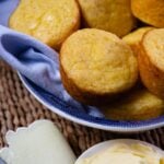 Beautifully baked corn muffins made with creamed corn and served with butter.