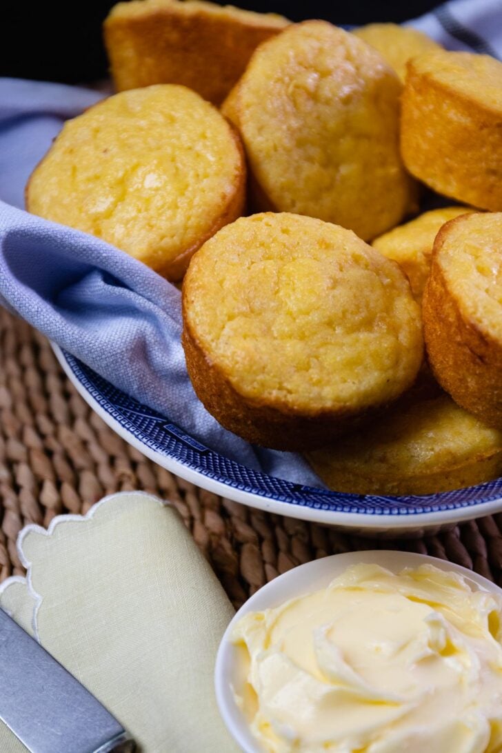 Beautifully baked corn muffins made with creamed corn and served with butter.