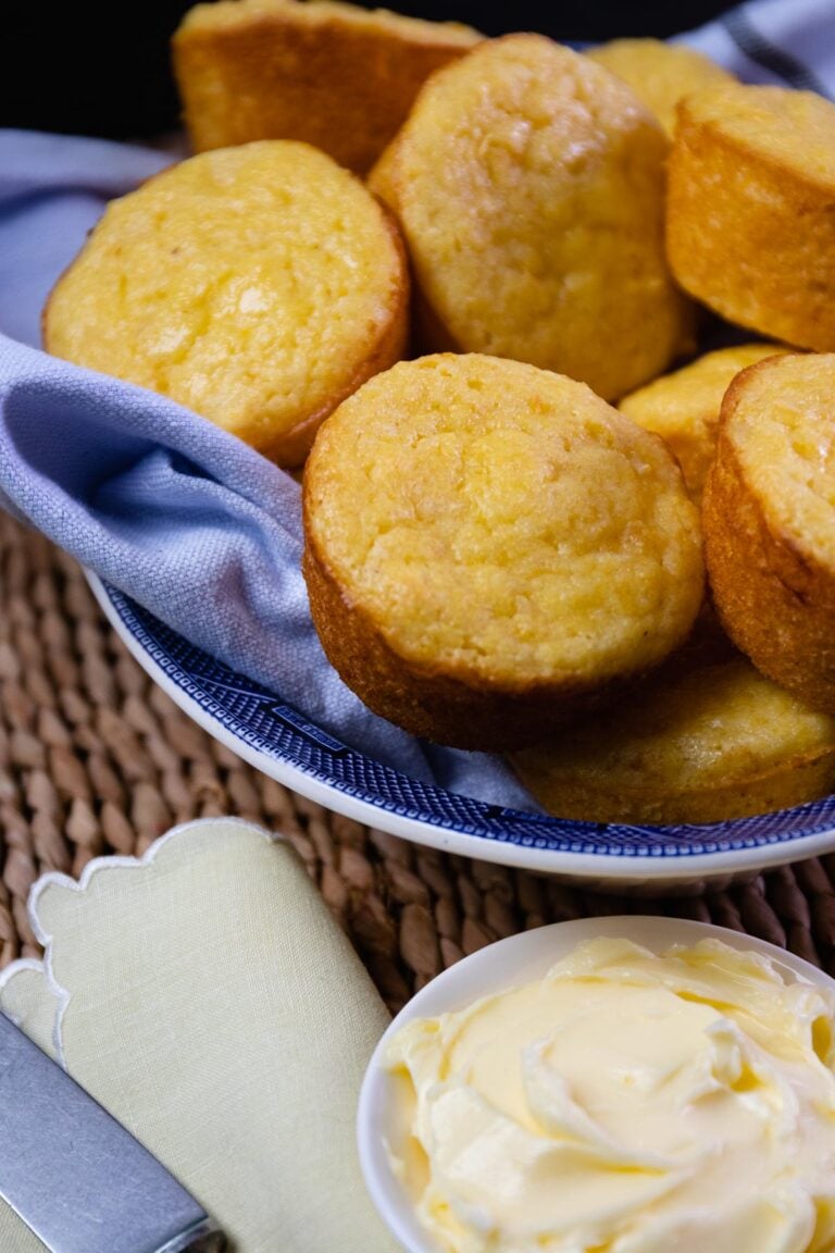 Beautifully baked corn muffins made with creamed corn and served with butter.