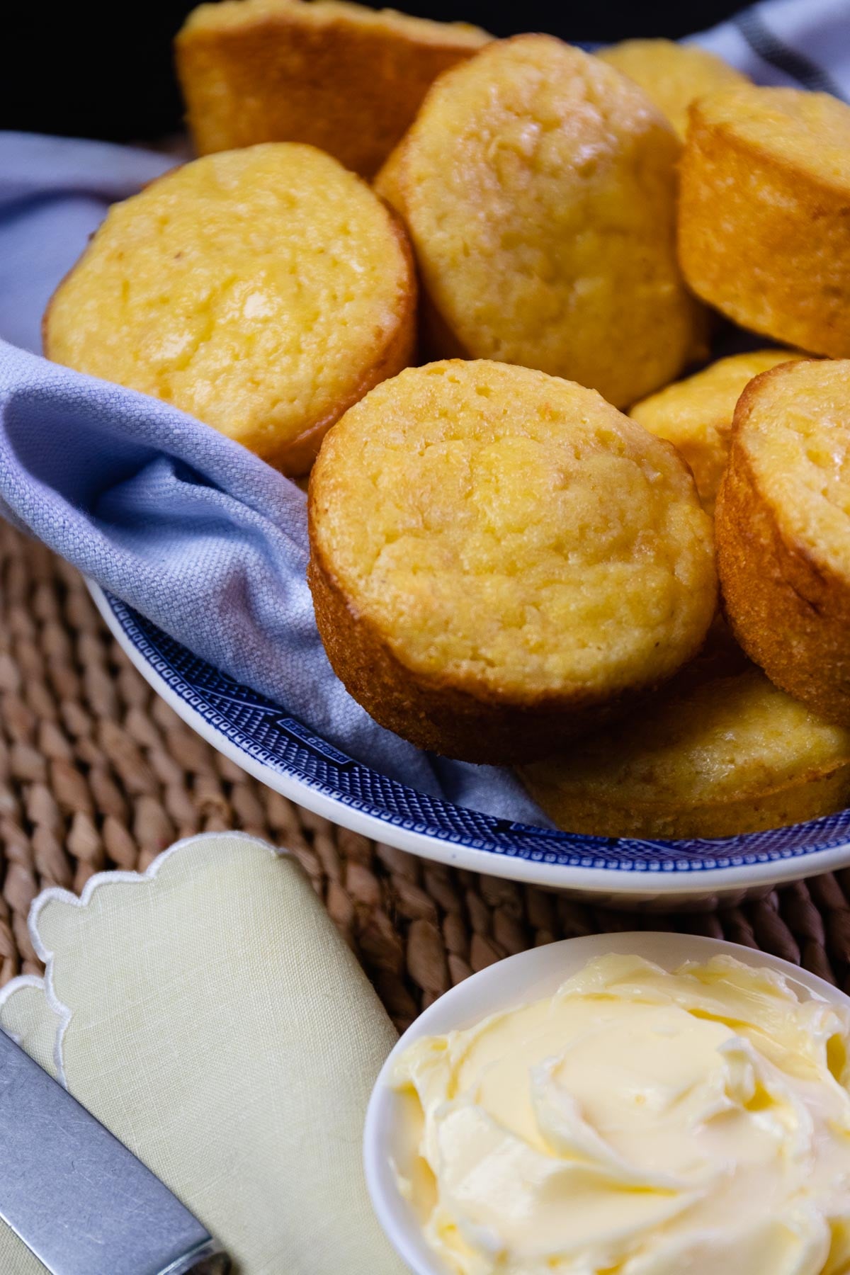 Beautifully baked corn muffins made with creamed corn and served with butter.