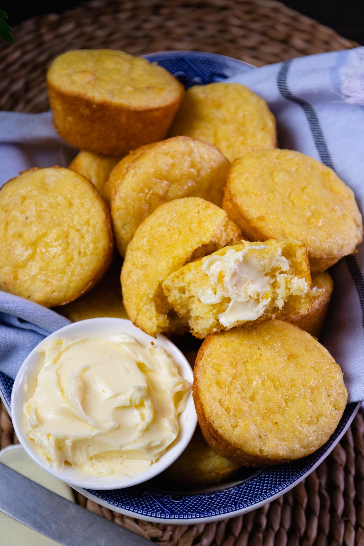 Corn Muffins served with butter, warm in a blue bowl for lunch or dinner.